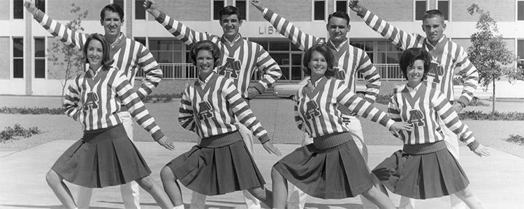 Arlington State College cheerleaders in front of library