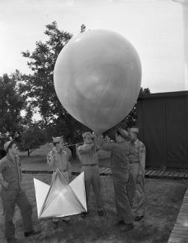 servicemen demonstrating weather balloon
