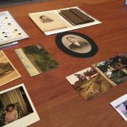 various photographic archives layed out on brown wood table