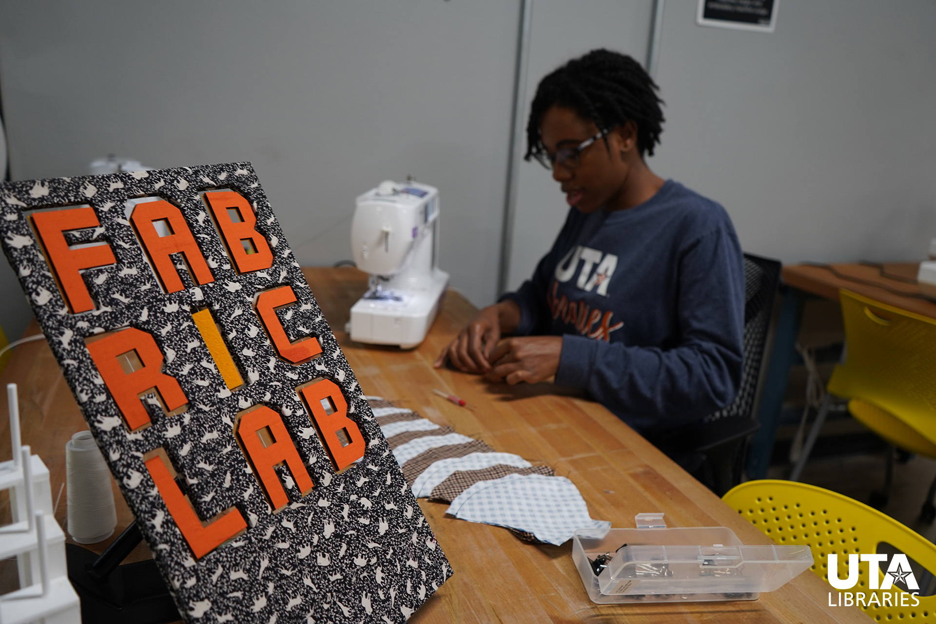 mia perkins works on face masks in the fablab