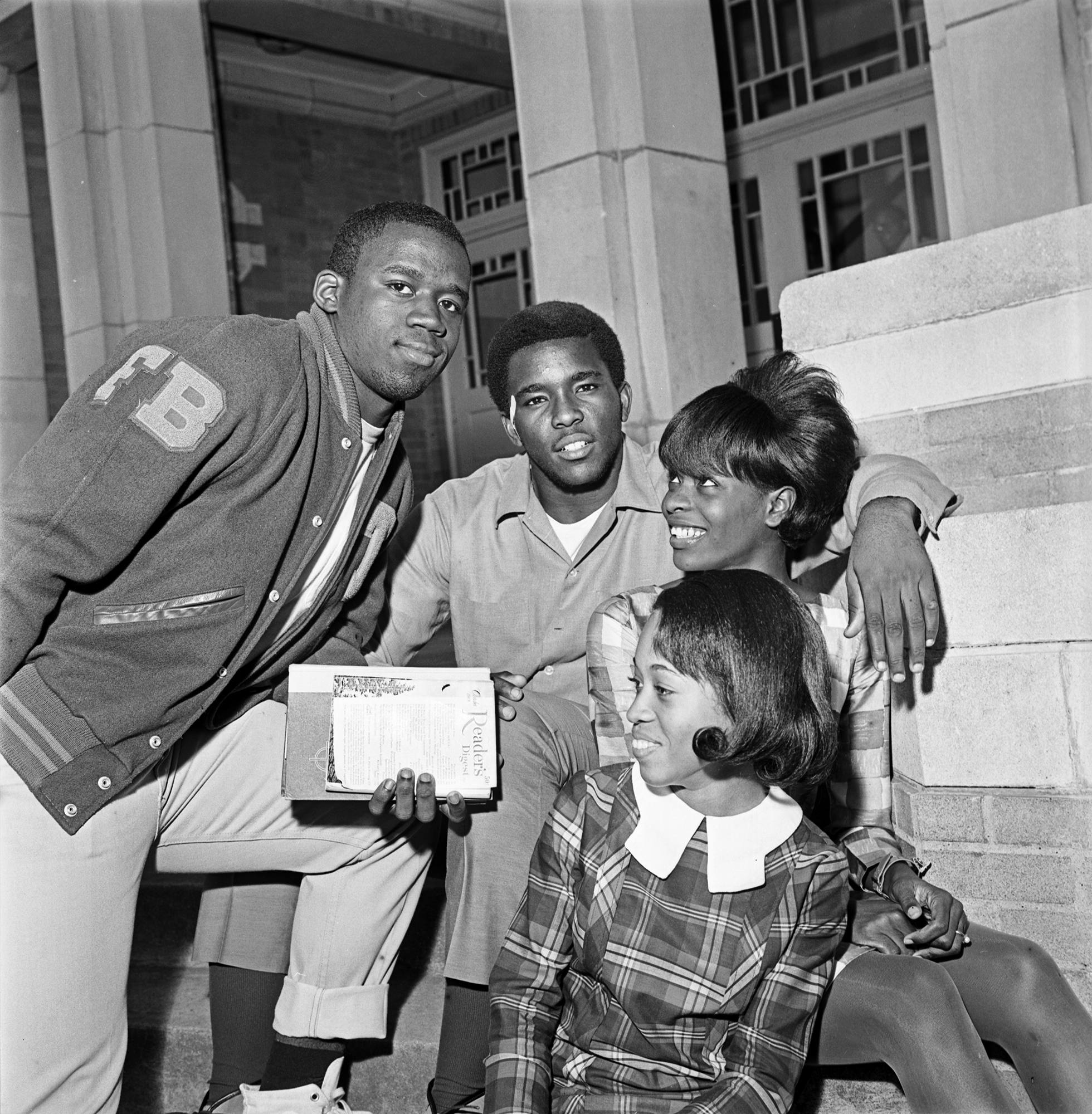 I. M. Terrell High School football players Joshua Smith, left, and Joel Williams are pictured with Teresa Barrett, top right, and Edwena Chandler during a class break.