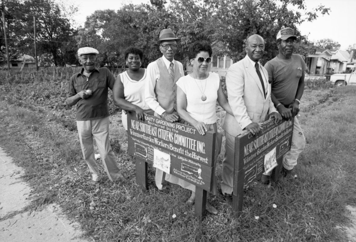 Members of the Near Southeast Citizens Committee Inc. posing next to the sign for the community garden at the corner of New York Avenue and East Myrtle Street, Fort Worth, Texas. Members include, from left, Joe Echols, Dottie Sims, Calvin Littlejohn, Ophelia Furlow, Moses Brown, and L. T. Stewart.