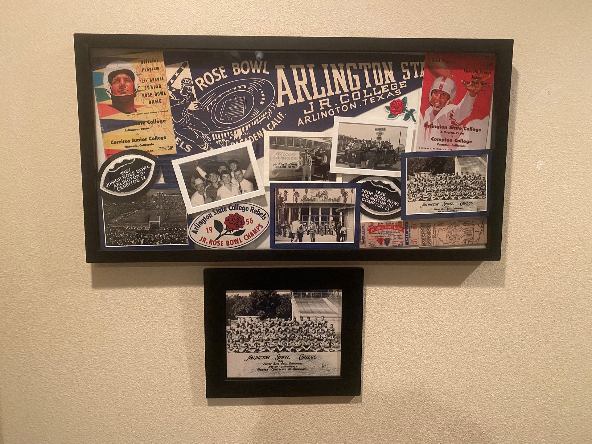 A shadow box featuring tons of memorabilia of Arlington State College's 1956 Junior Rose Bowl win, include the program, a ticket, a pennant, and photos.