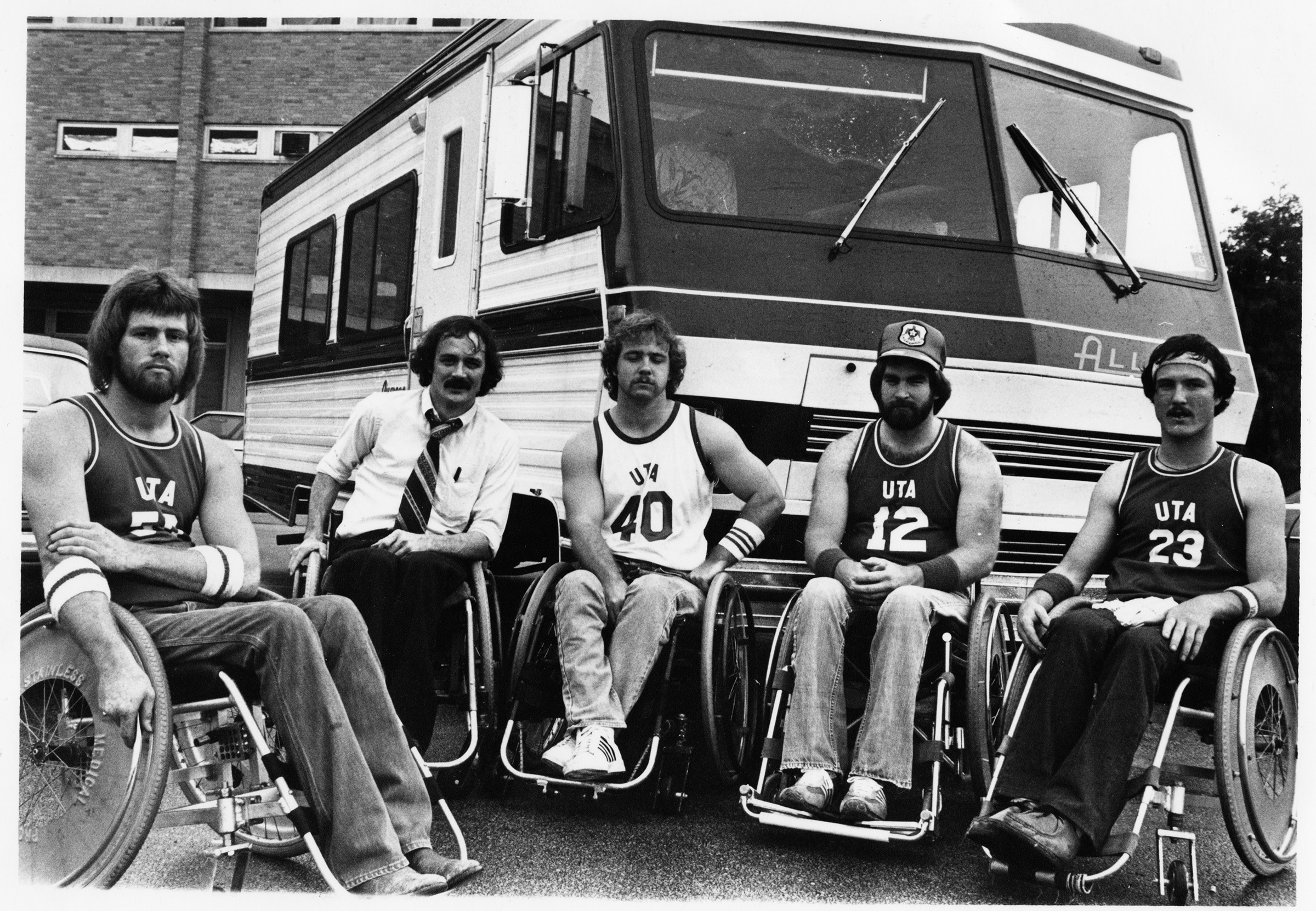Five members of the U. T. A. Movin' Mavs basketball team in front of a van; from left, Danny Williams, Jim Hayes, Chris Cooper, Jimmie Strader, Eddie Bland