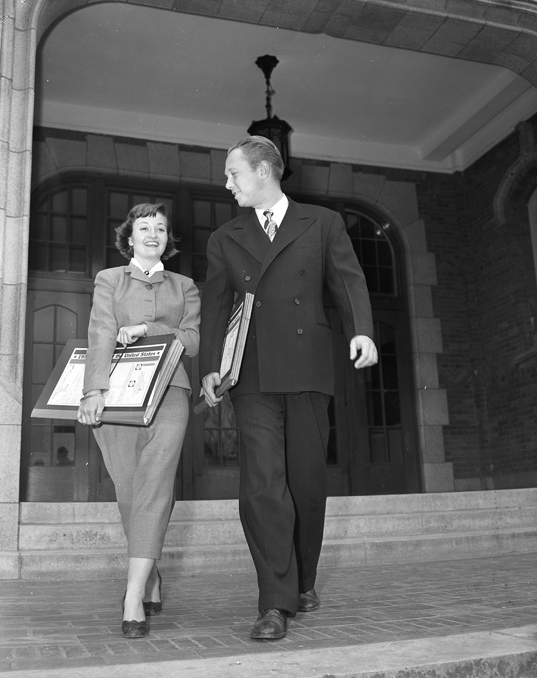 Miss Betty L. Hudson, left, and Thomas G. Agnew, right, census enumerators, leave Paschal High School. March 1950. 