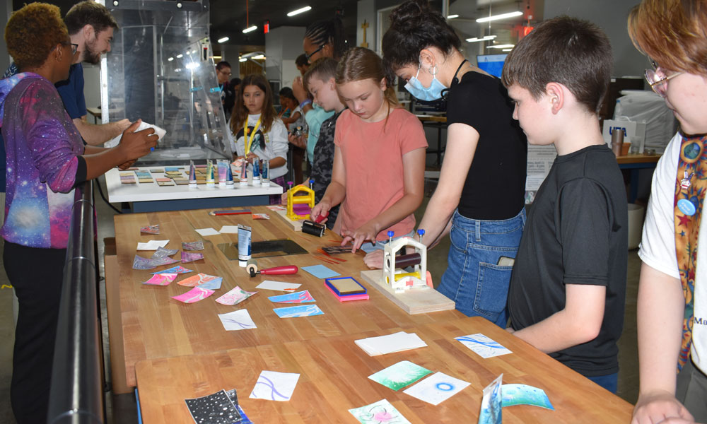 students printing space-themed cards