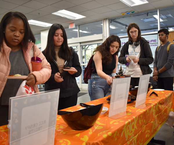 Students gets some Halloween treats at the UTA Central Library on Monday, Oct. 31.