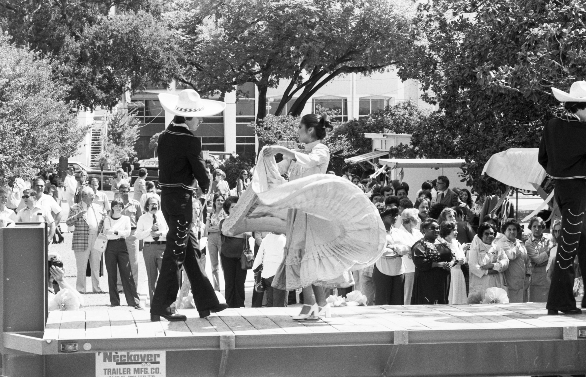 Black and white photo of a traditional Mexican folklorico dancer performance on a stage.