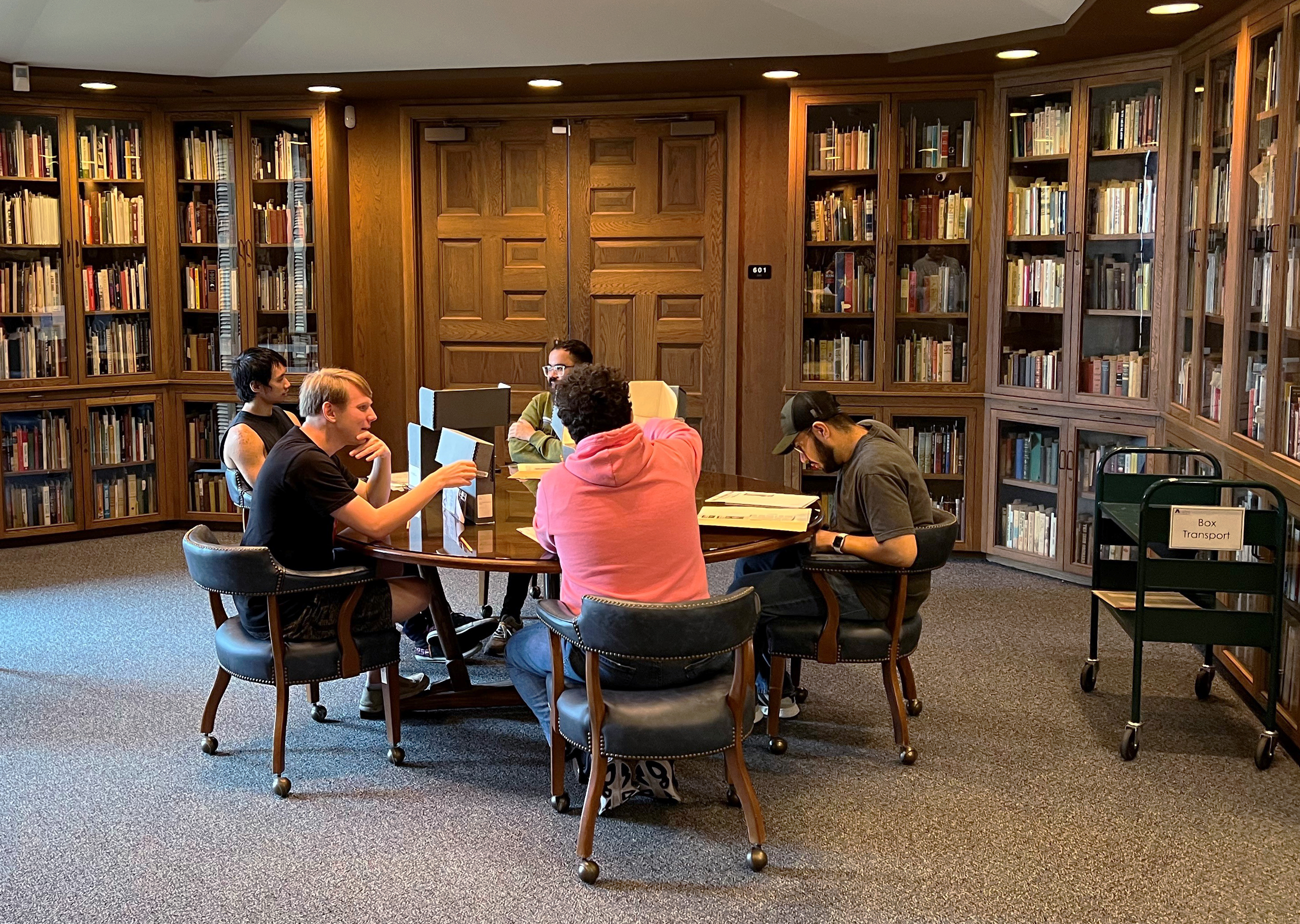 Students studying materials around a table in Special Collections.