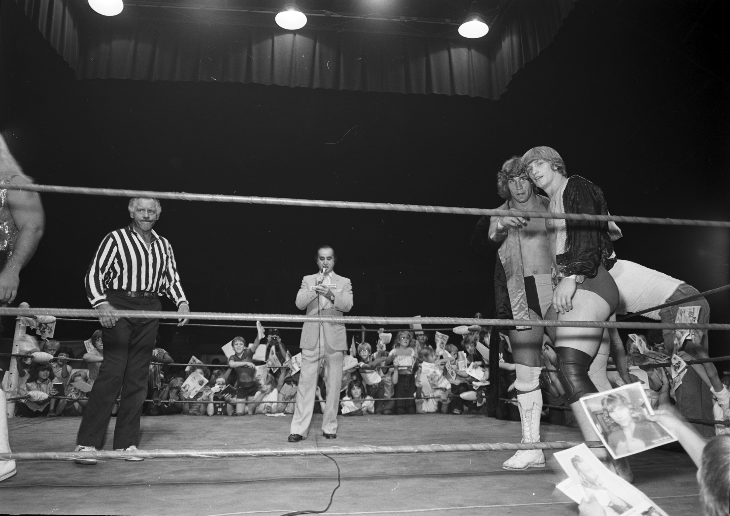 Wrestling at Will Rogers Coliseum, Fort Worth, Texas ca. 1981-82; Kerry Von Erich and Kevin Von Erich at far right, ring announcer Joe Rinelli, and unidentified referee