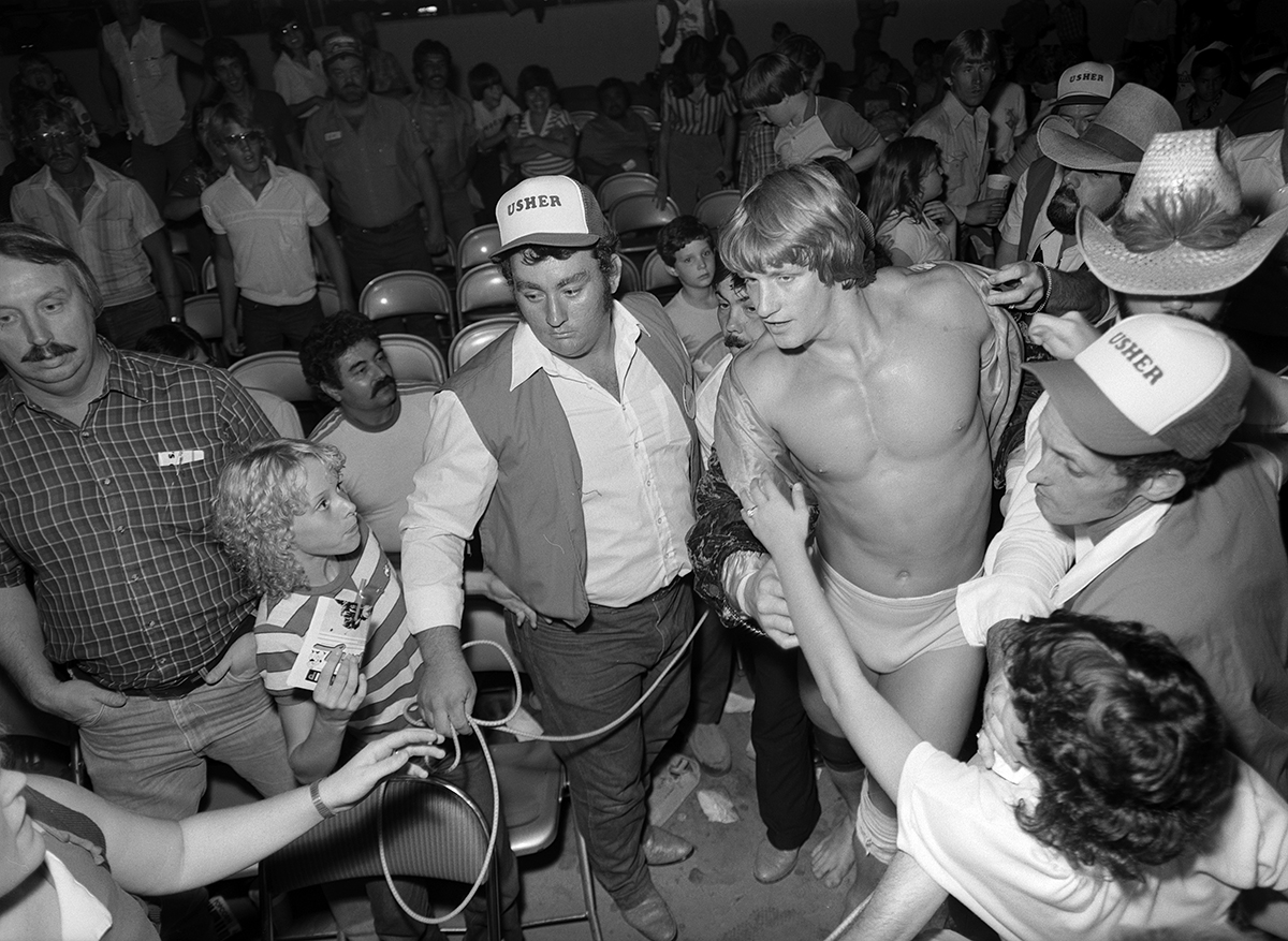 Wrestling at Will Rogers Coliseum, Fort Worth, Texas ca. 1981-82; Kevin Von Erich walking towards the ring through a crowd of people
