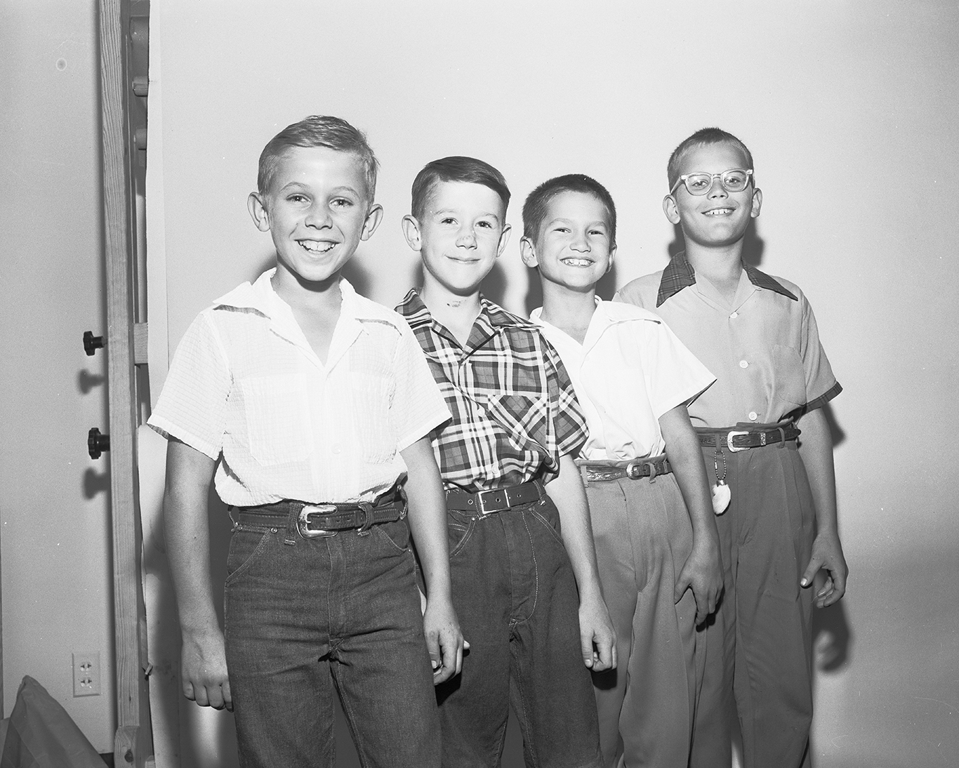 Group of four boys posed for a picture.