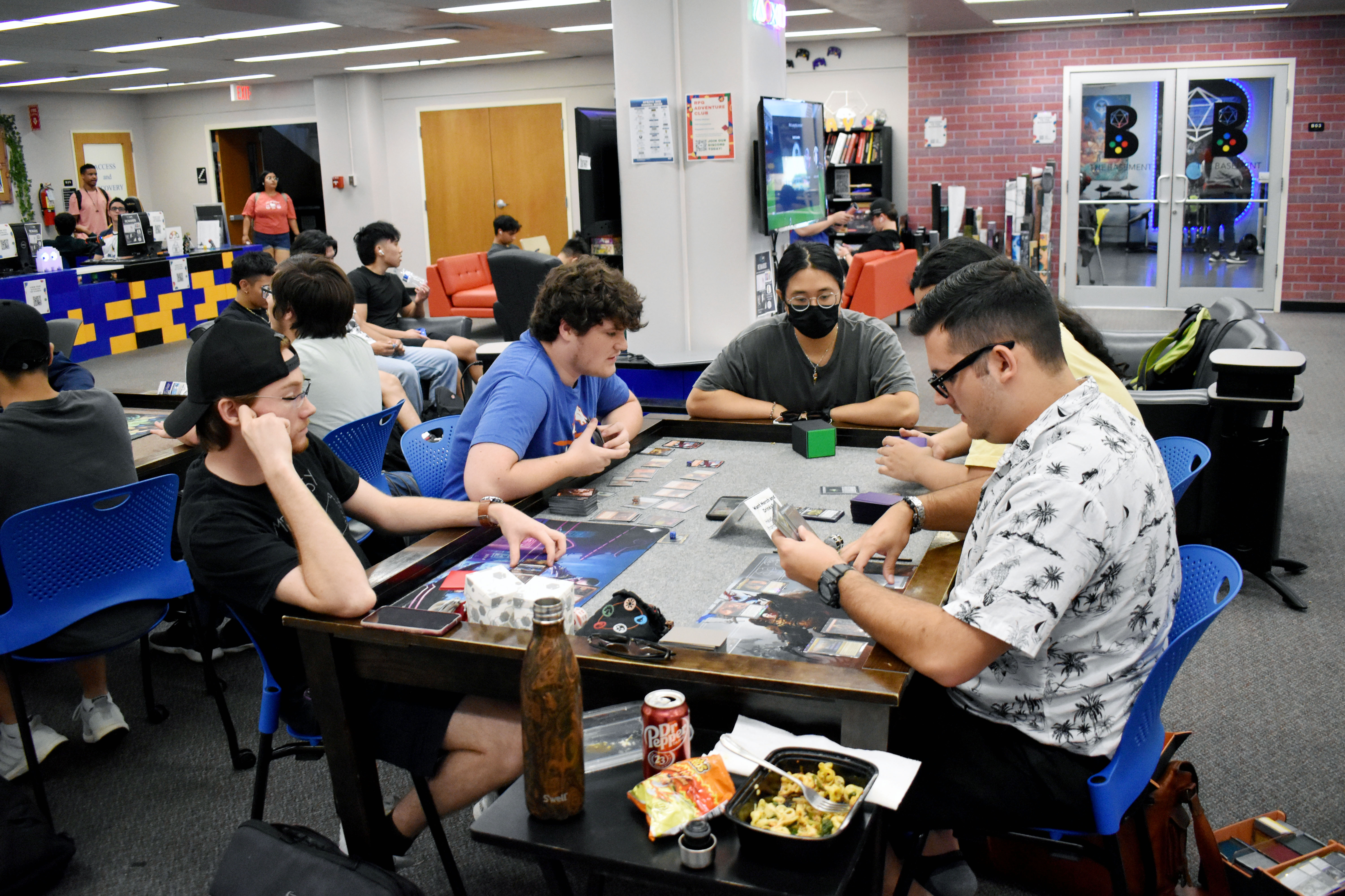 students playing card games in The Basement
