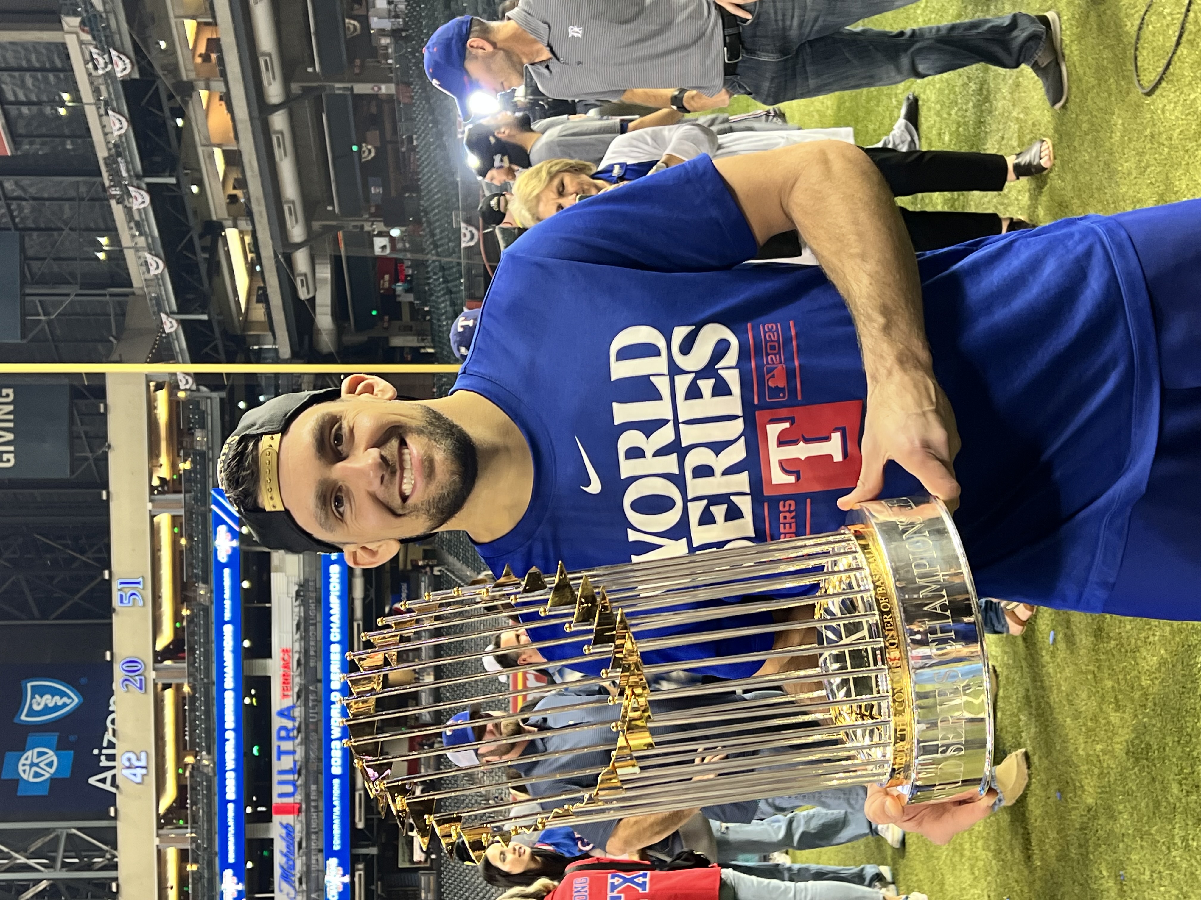 Nathan Eovaldi holding the World Series trophy after the Rangers won. 