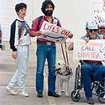 Disability Rights Protesters in a wheelchair and holding signs