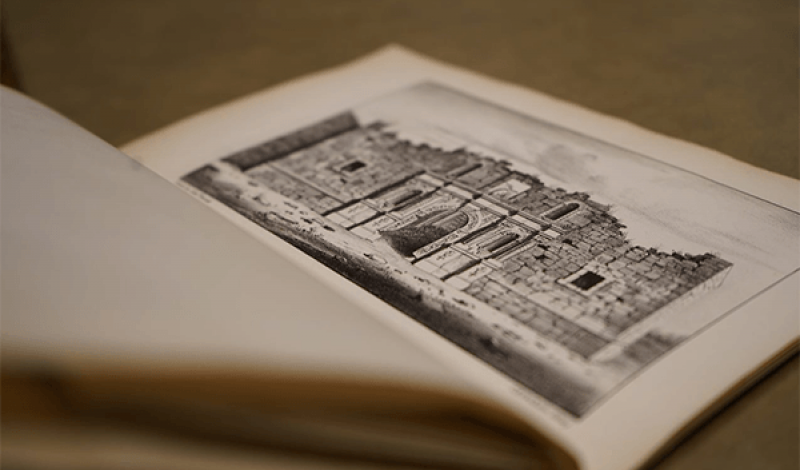 old book open showing illustration of The Alamo