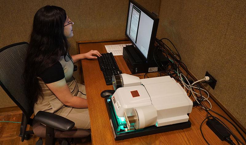 person using a microfilm machine