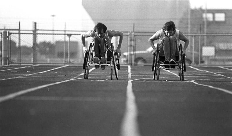 To athletes racing on track in wheelchairs