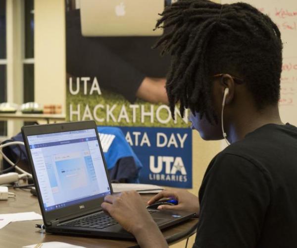 Hackathon student working at laptop
