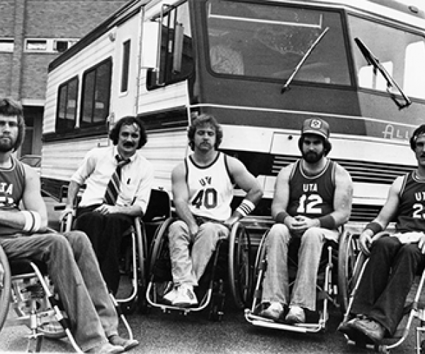 basketball players in wheelchairs in front of bus