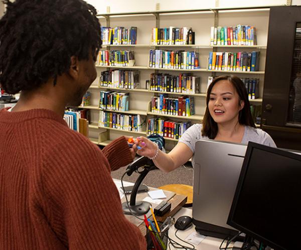 Guest Services helping student at Science and Engineering Library