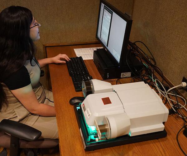 person using a microfilm machine