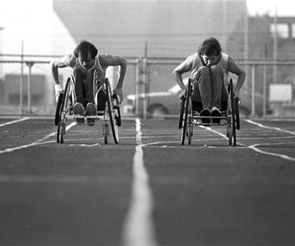 To athletes racing on track in wheelchairs