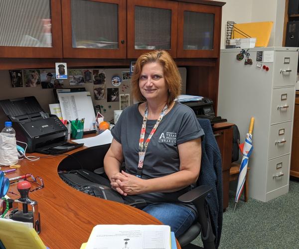 bonnie dreitner sitting at her desk at UTA Libraries 