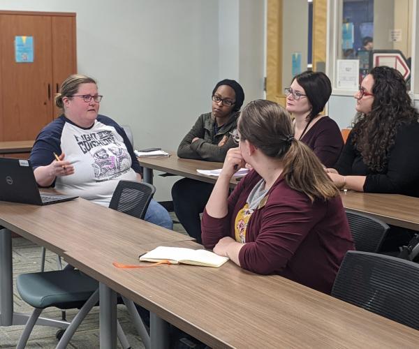 Five women meeting around two tables at UTA Libraries