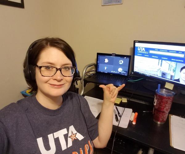 laura haygood giving a mav up in front of her computer