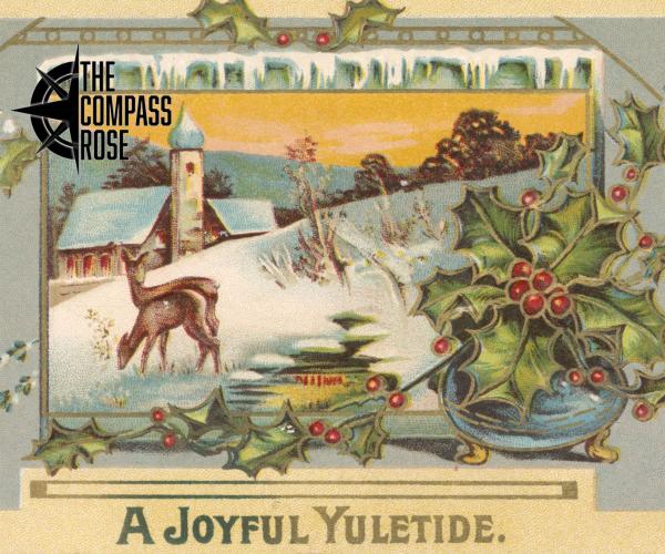 The face of a greeting card with "A Joyful Yuletide" in text at the bottom of the card and a wintry holiday scene with snow and holly leaves and deer and (possibly) a church building in the background.