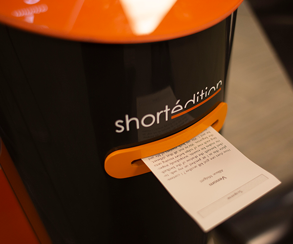 a close up of the short edition machine printing a story in central library