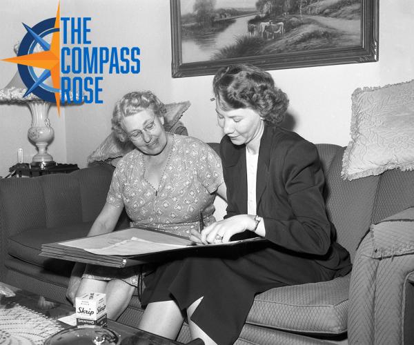 Two women sit on a couch as they write out census information, 1950. Compass Rose logo at top right.