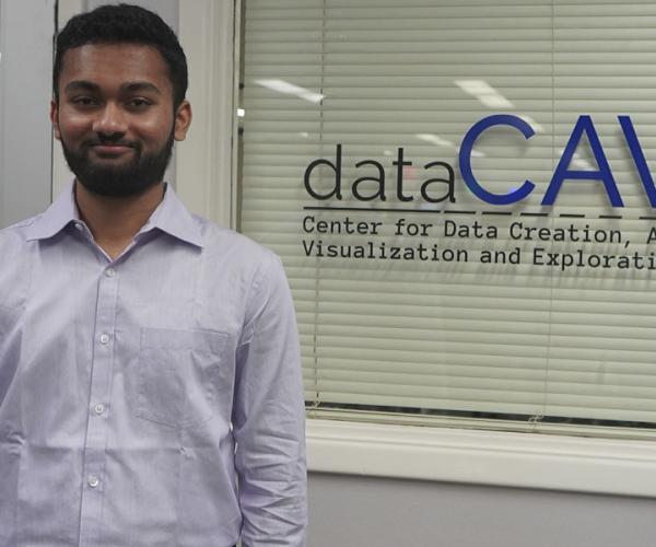 Nihal Kumarswamy posing outside dataCAVE room