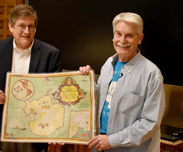 Huseman and Finfrock holding map of Antarctica