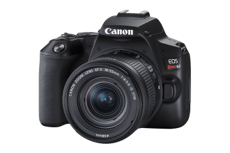 "Image of a Canon SL3 camera, a compact DSLR featuring a lens attached to the body. The camera boasts a flip-out LCD screen and various buttons for control, ideal for both photography and videography. Known for its lightweight design and user-friendly interface, the Canon SL3 is favored by entry-level photographers and enthusiasts alike."